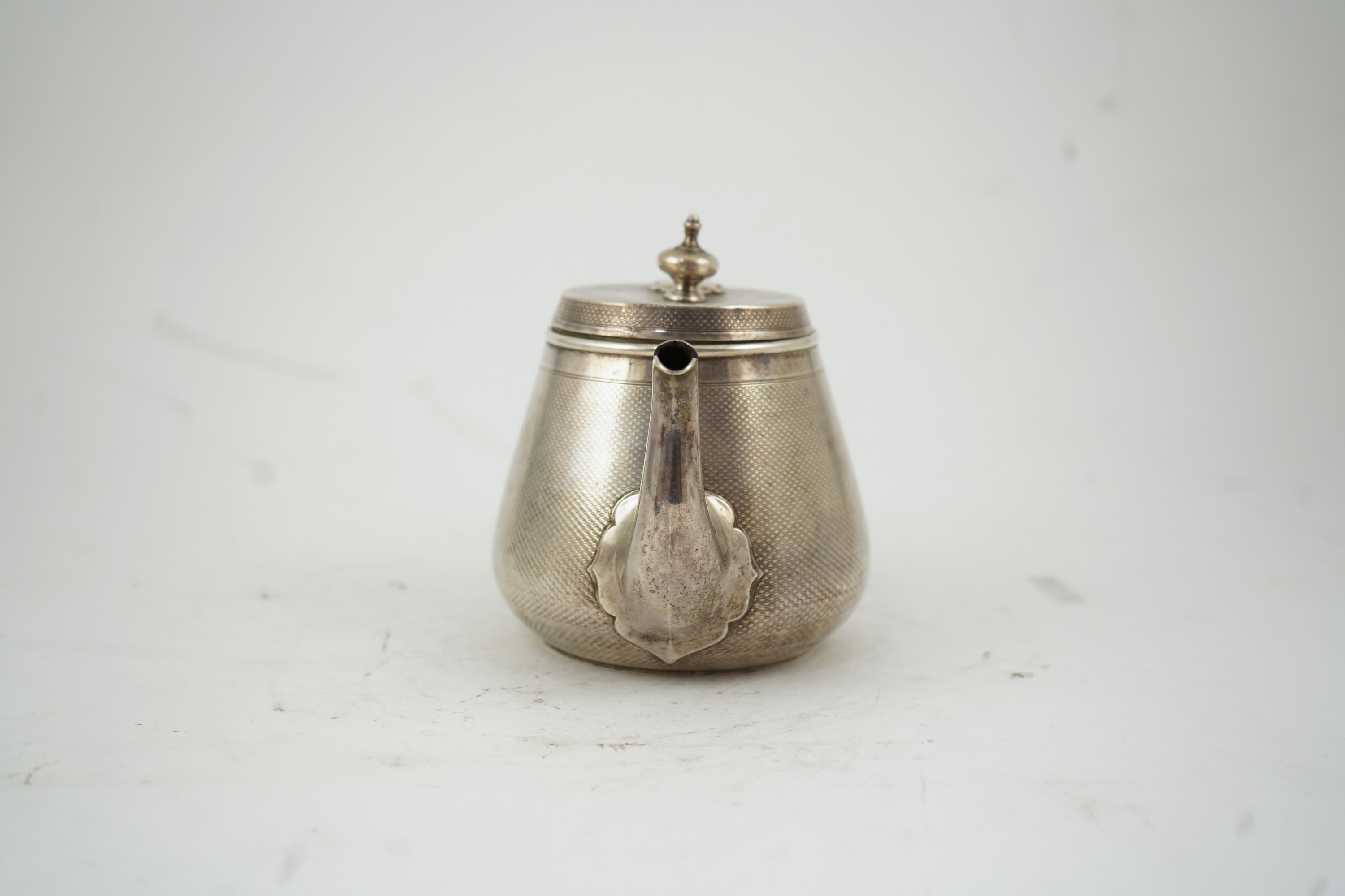 A Victorian engine turned silver teapot by Hunt & Roskell
